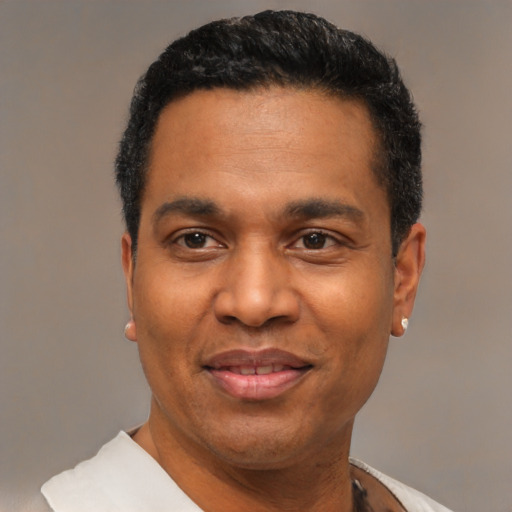 Joyful latino adult male with short  black hair and brown eyes