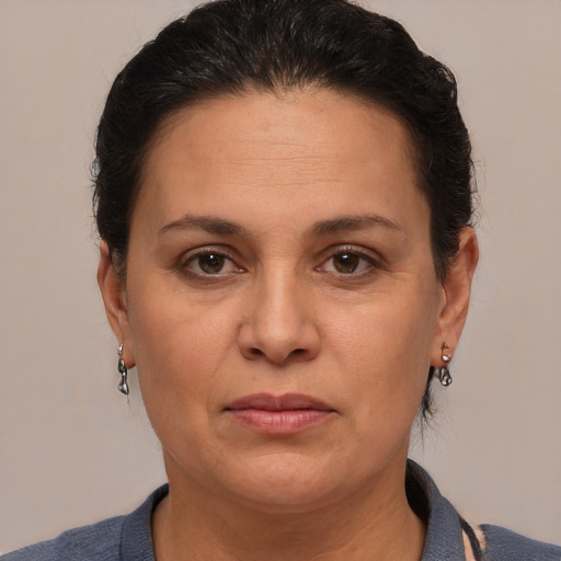 Joyful white adult female with medium  brown hair and brown eyes