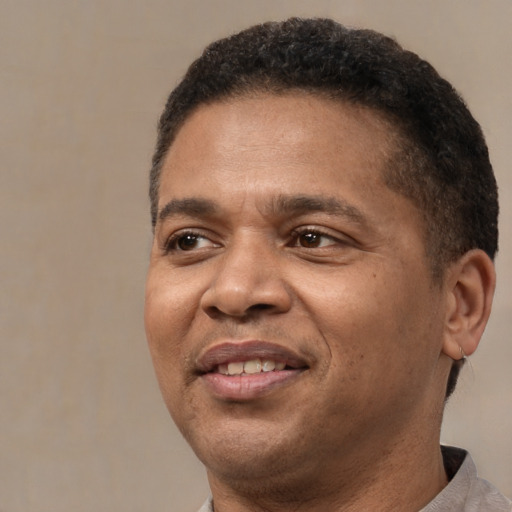 Joyful latino adult male with short  brown hair and brown eyes