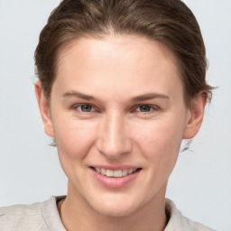 Joyful white young-adult female with short  brown hair and grey eyes