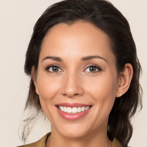 Joyful white young-adult female with medium  brown hair and brown eyes