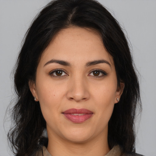 Joyful latino young-adult female with long  brown hair and brown eyes