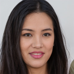 Joyful asian young-adult female with long  brown hair and brown eyes