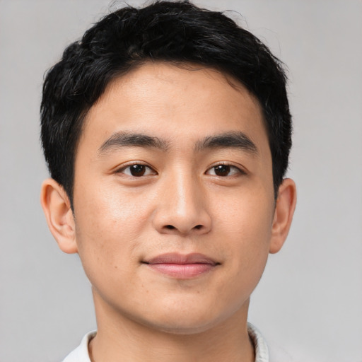 Joyful asian young-adult male with short  black hair and brown eyes