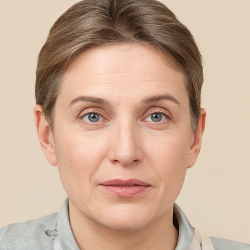 Joyful white adult female with short  brown hair and grey eyes