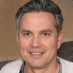 Joyful white middle-aged male with short  brown hair and brown eyes