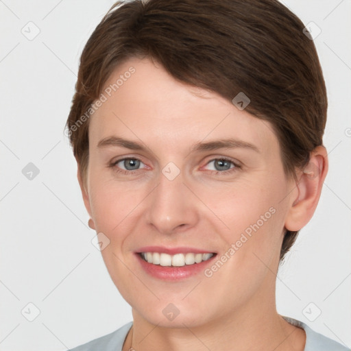 Joyful white young-adult female with short  brown hair and grey eyes