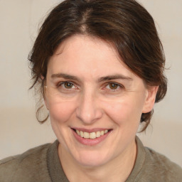 Joyful white adult female with medium  brown hair and brown eyes