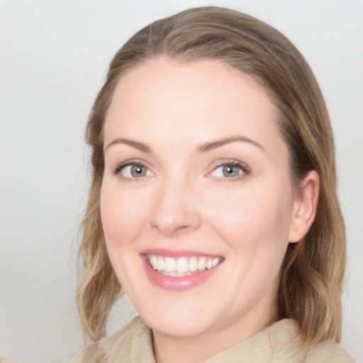 Joyful white young-adult female with medium  brown hair and blue eyes