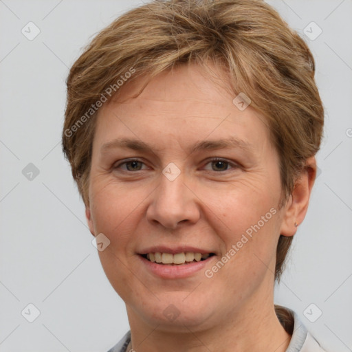 Joyful white adult female with short  brown hair and grey eyes