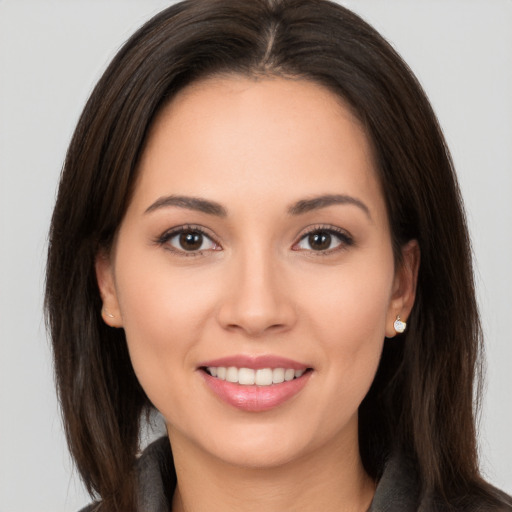 Joyful white young-adult female with long  brown hair and brown eyes