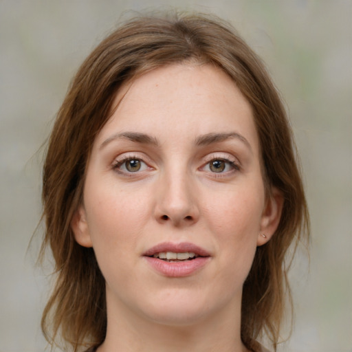 Joyful white young-adult female with medium  brown hair and blue eyes