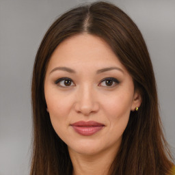 Joyful asian young-adult female with long  brown hair and brown eyes