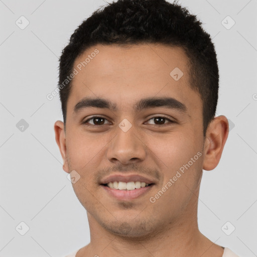 Joyful latino young-adult male with short  black hair and brown eyes