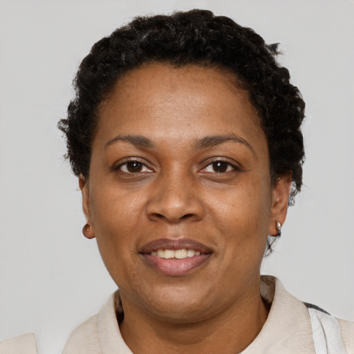 Joyful black adult female with short  brown hair and brown eyes