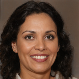 Joyful white adult female with long  brown hair and brown eyes