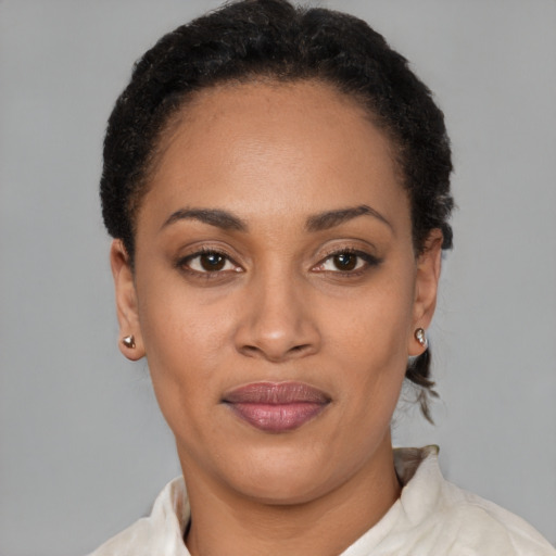 Joyful latino young-adult female with short  black hair and brown eyes
