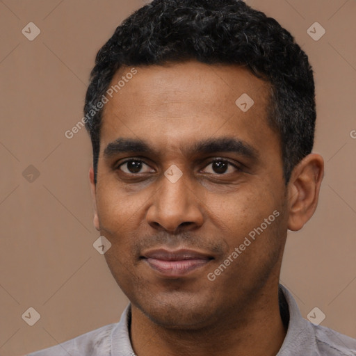 Joyful latino young-adult male with short  black hair and brown eyes