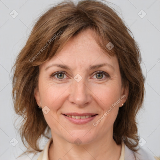 Joyful white adult female with medium  brown hair and grey eyes