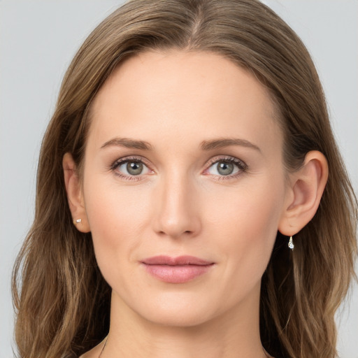 Joyful white young-adult female with long  brown hair and blue eyes