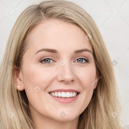 Joyful white young-adult female with long  brown hair and blue eyes