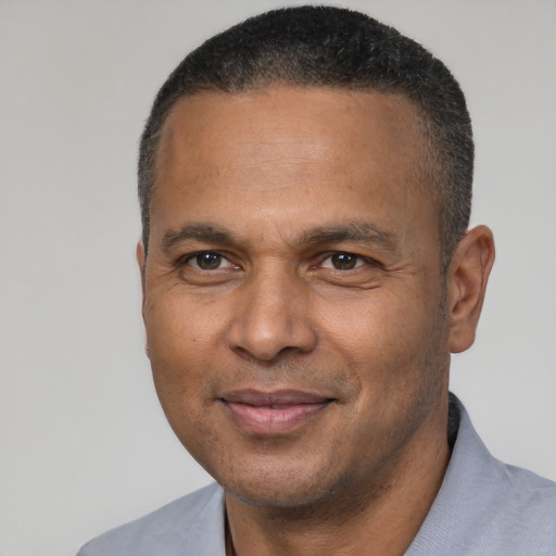 Joyful latino adult male with short  black hair and brown eyes