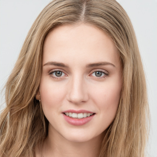 Joyful white young-adult female with long  brown hair and green eyes