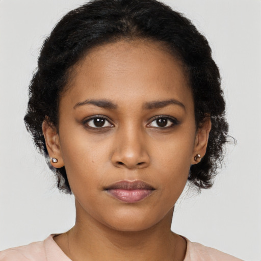 Neutral black young-adult female with long  brown hair and brown eyes