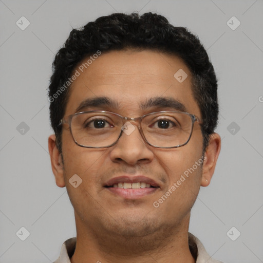 Joyful latino adult male with short  black hair and brown eyes