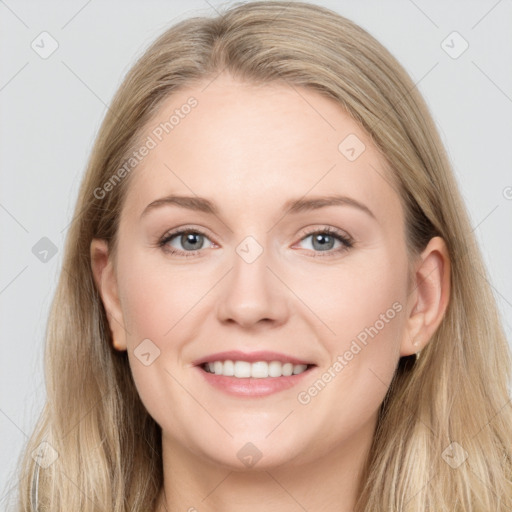 Joyful white young-adult female with long  brown hair and blue eyes