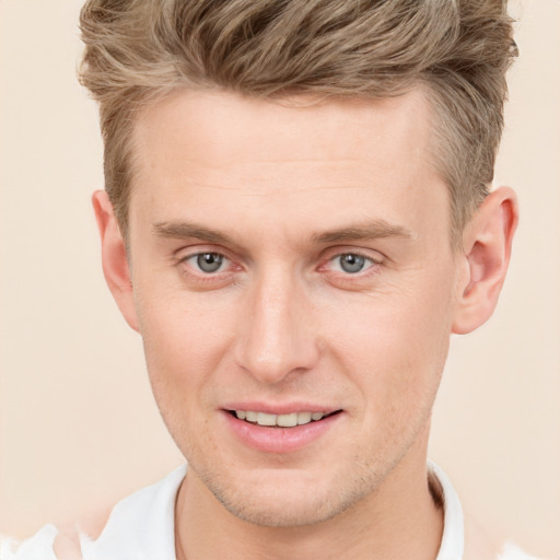 Joyful white young-adult male with short  brown hair and grey eyes