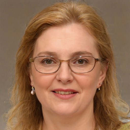 Joyful white adult female with medium  brown hair and green eyes