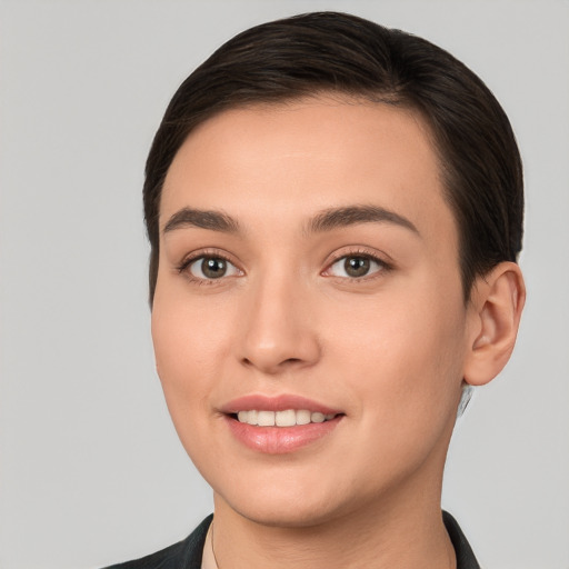 Joyful white young-adult female with short  brown hair and brown eyes