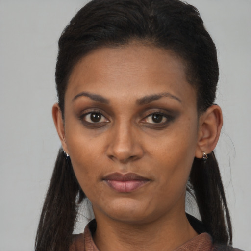 Neutral black young-adult female with long  brown hair and brown eyes