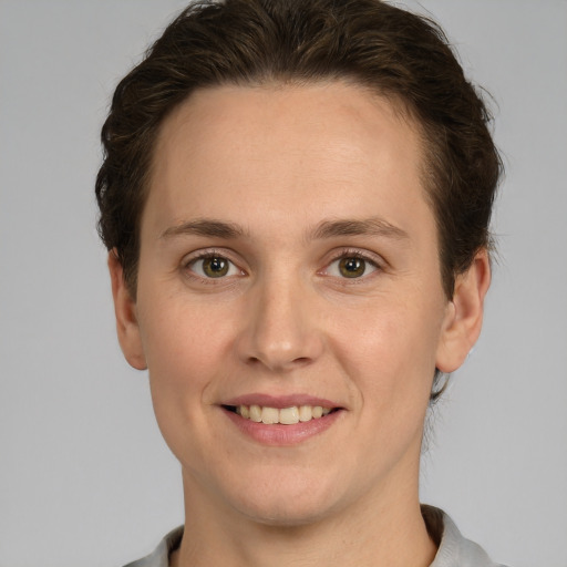 Joyful white young-adult female with short  brown hair and grey eyes