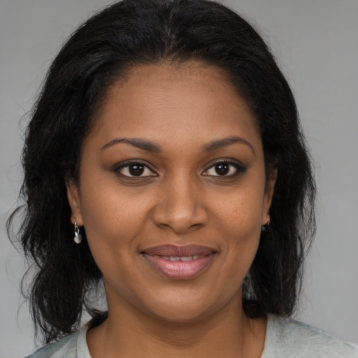 Joyful black young-adult female with medium  brown hair and brown eyes