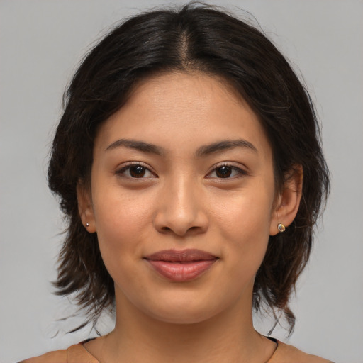 Joyful asian young-adult female with medium  brown hair and brown eyes