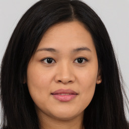 Joyful asian young-adult female with long  brown hair and brown eyes