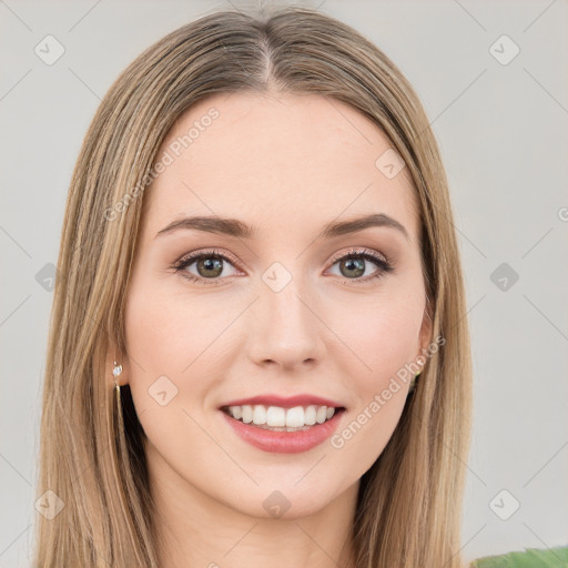 Joyful white young-adult female with long  brown hair and green eyes