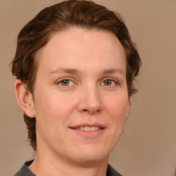 Joyful white adult female with short  brown hair and grey eyes