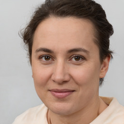 Joyful white adult female with medium  brown hair and brown eyes