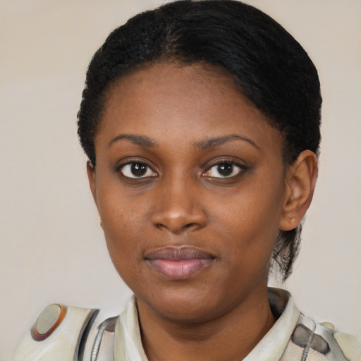 Joyful black young-adult female with short  brown hair and brown eyes