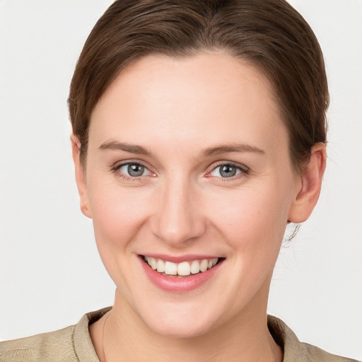 Joyful white young-adult female with short  brown hair and grey eyes