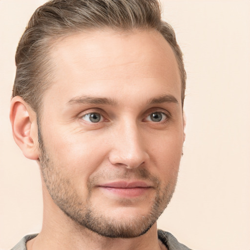 Joyful white young-adult male with short  brown hair and grey eyes