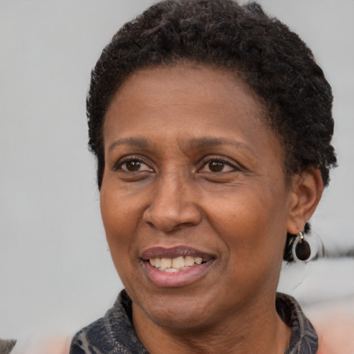 Joyful latino adult female with short  brown hair and brown eyes
