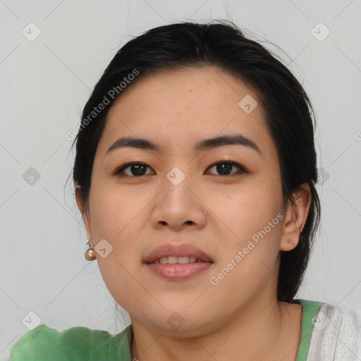 Joyful asian young-adult female with medium  black hair and brown eyes