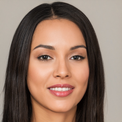 Joyful white young-adult female with long  black hair and brown eyes