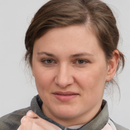 Joyful white young-adult female with short  brown hair and blue eyes