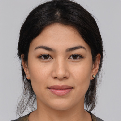 Joyful latino young-adult female with medium  brown hair and brown eyes