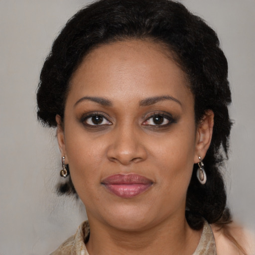 Joyful black young-adult female with long  brown hair and brown eyes